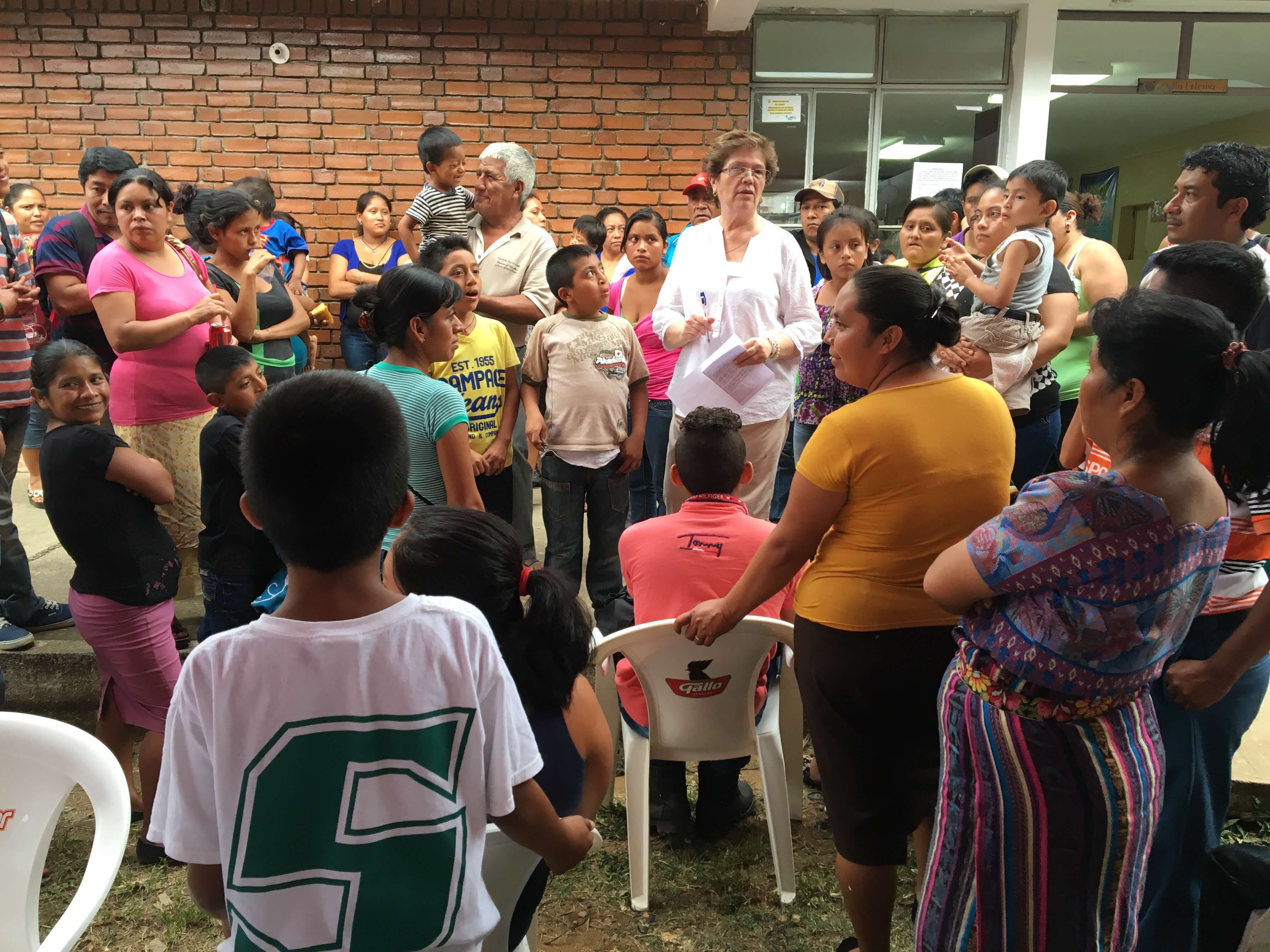Belia Contreras, a Rotary Club of Guatemala City employee and one of our translators, explains the registration and evaluation process to the potential patients' parents.