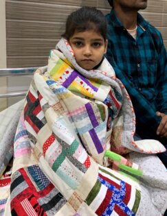 Child wrapped in quilt